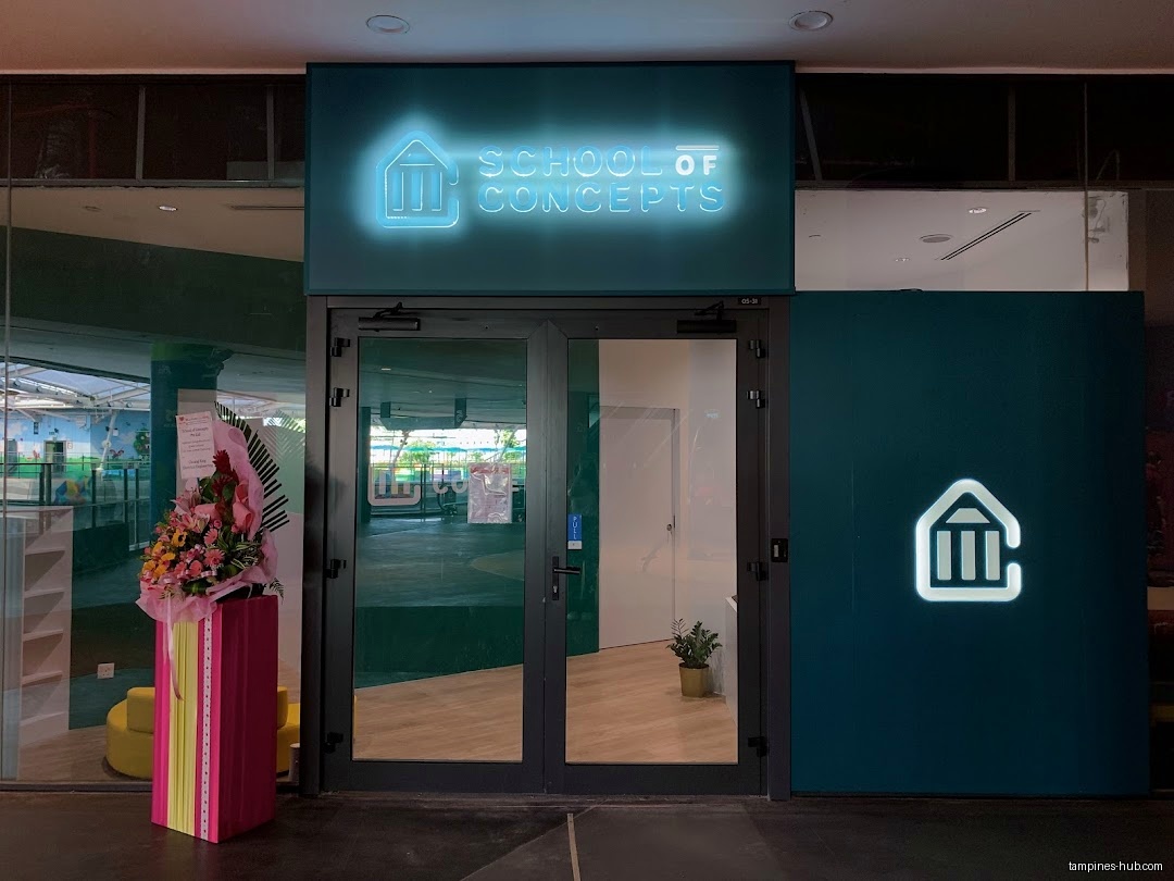 The shop front of School of Concepts with a neon sign.