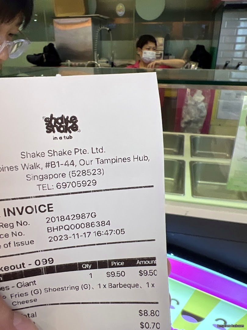 A receipt from Shake Shake in a Tub is held up.