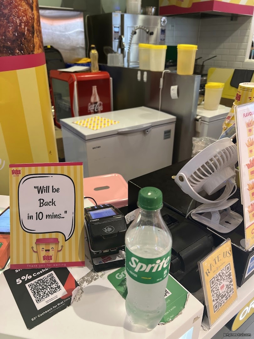 The image shows a counter with a Sprite bottle and a 'back in 10' sign.
