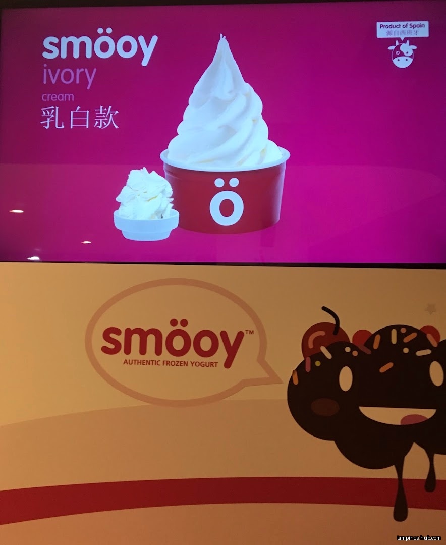 The image shows a Smöoy advertisement with frozen yogurt and cartoon character.