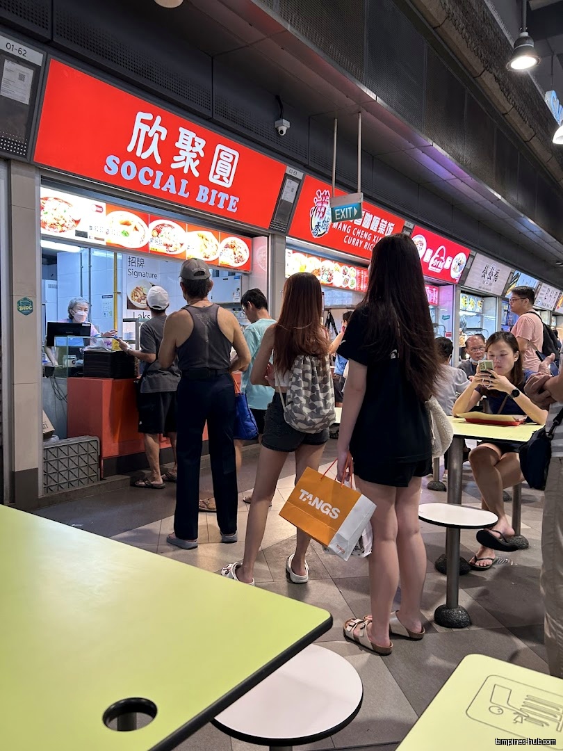 People queue at Social Bite, a food stall with a red sign.