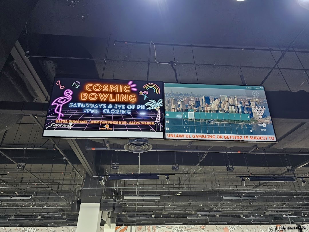 Two screens display bowling information and cosmic bowling event details.