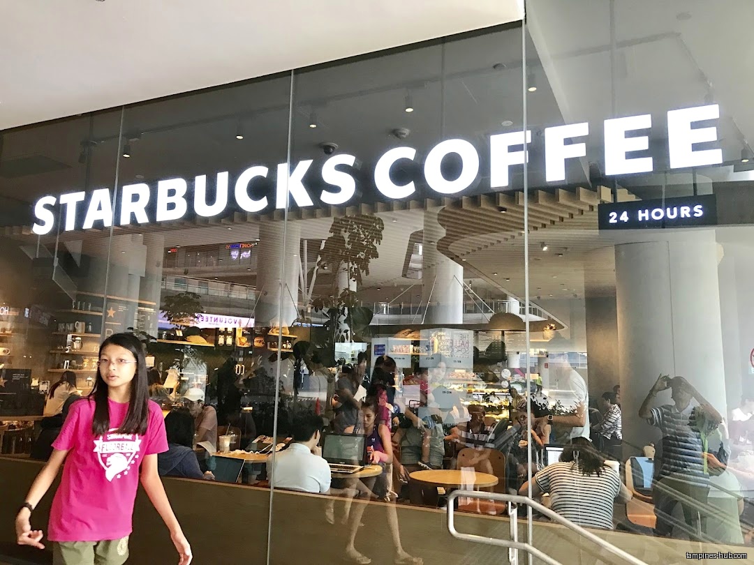 Starbucks Our Tampines Hub shop front with people inside and outside.