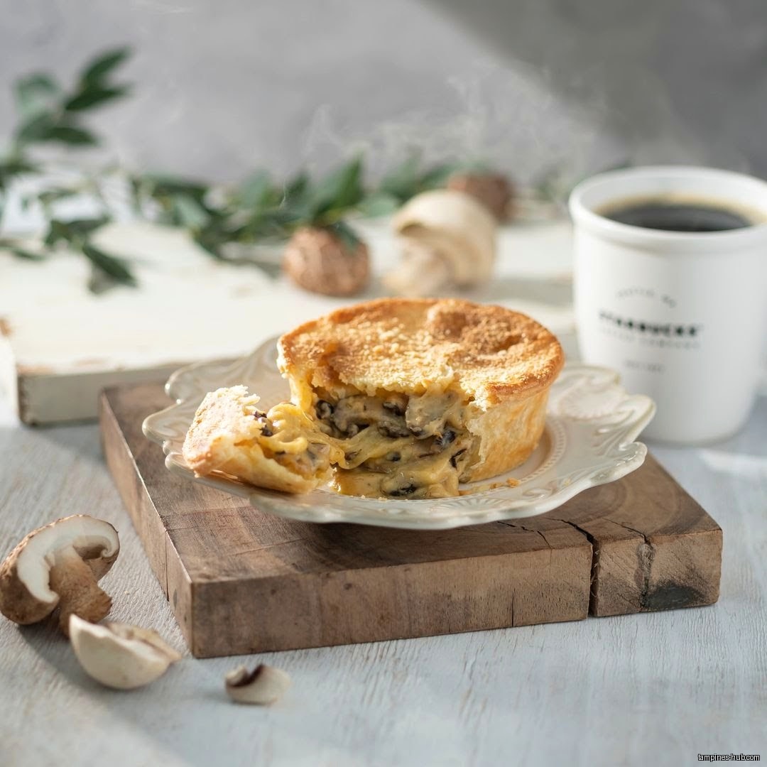 A mushroom pie and a Starbucks coffee cup are on display.