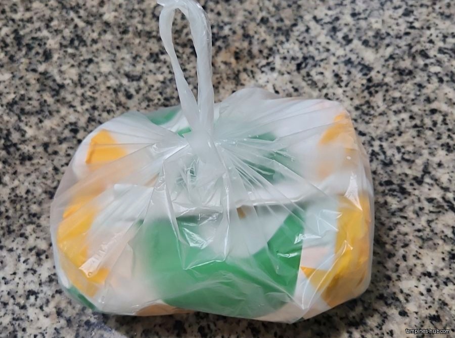 A plastic bag containing Subway-branded packaging on a countertop.