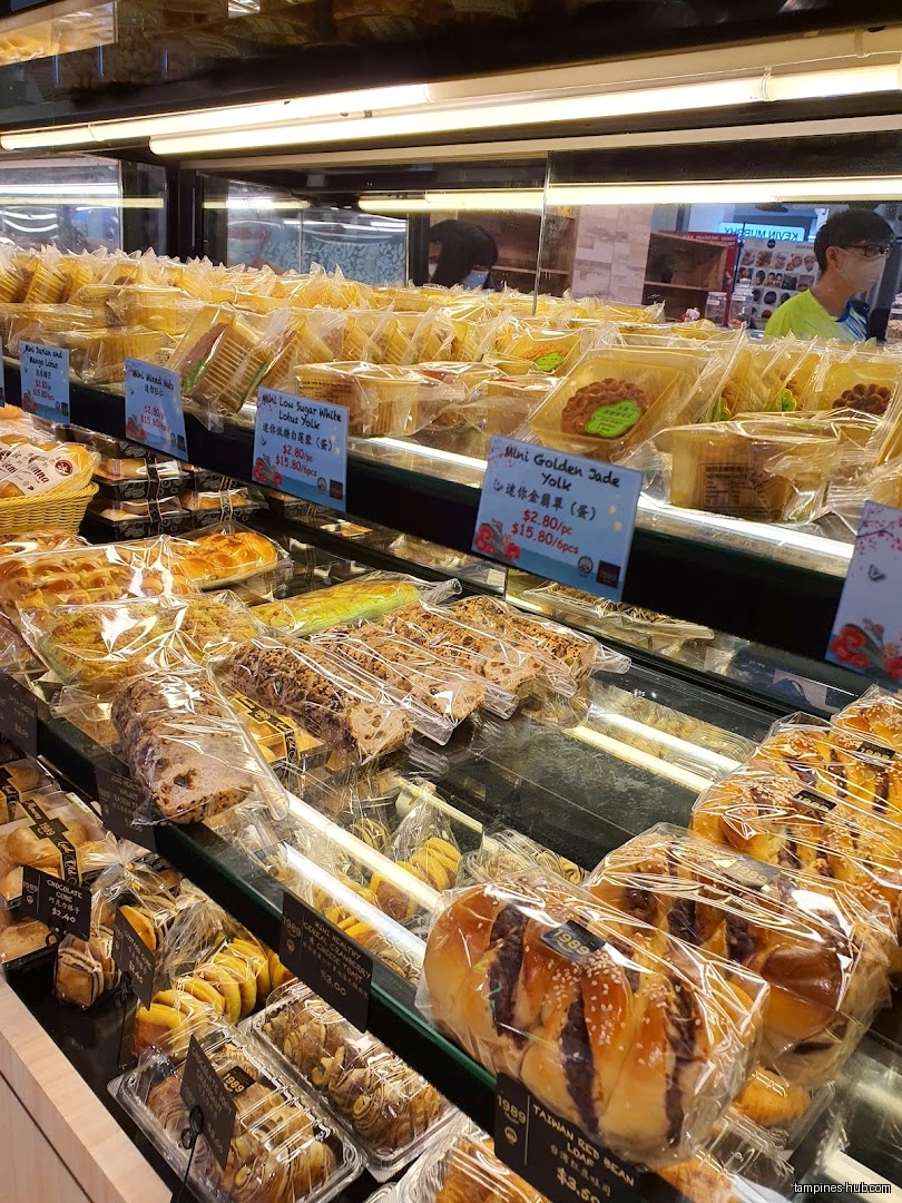 A display case filled with various packaged baked goods at Swee Heng 1989 Classic.