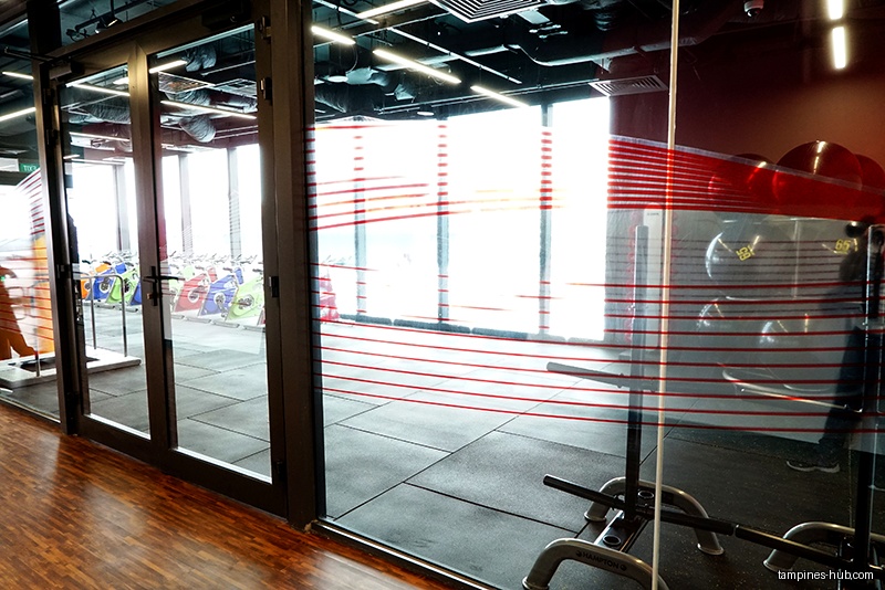 The image shows the interior of Tampines ActiveSG Gym with equipment.