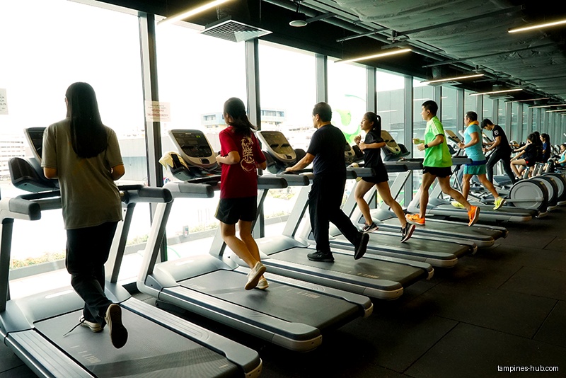 People are exercising on treadmills at Tampines ActiveSG Gym.