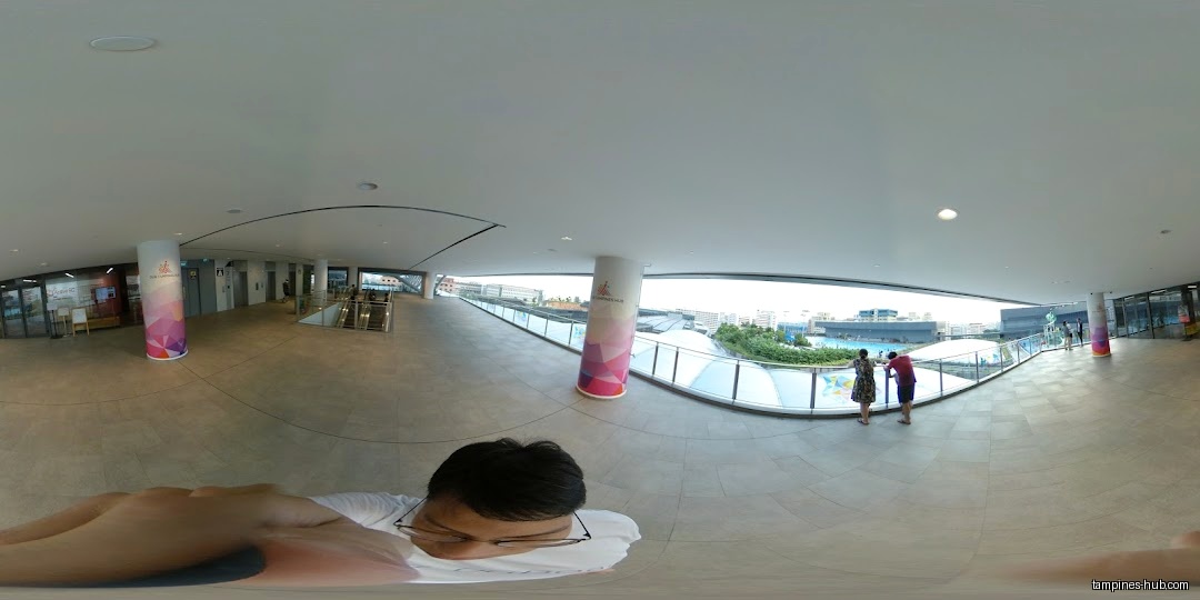 Interior view of Tampines ActiveSG Gym with people and a pool view.
