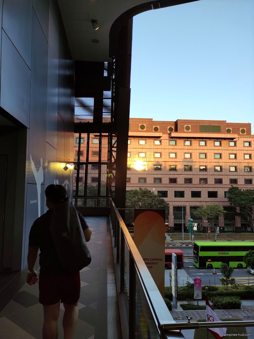 A person walks along a walkway near Tampines ActiveSG Gym.