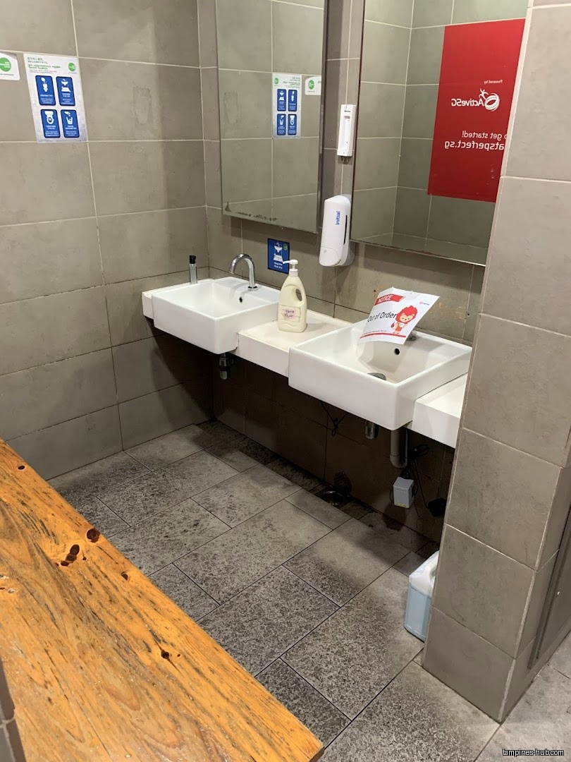 The image shows a bathroom with two sinks and a wooden bench.