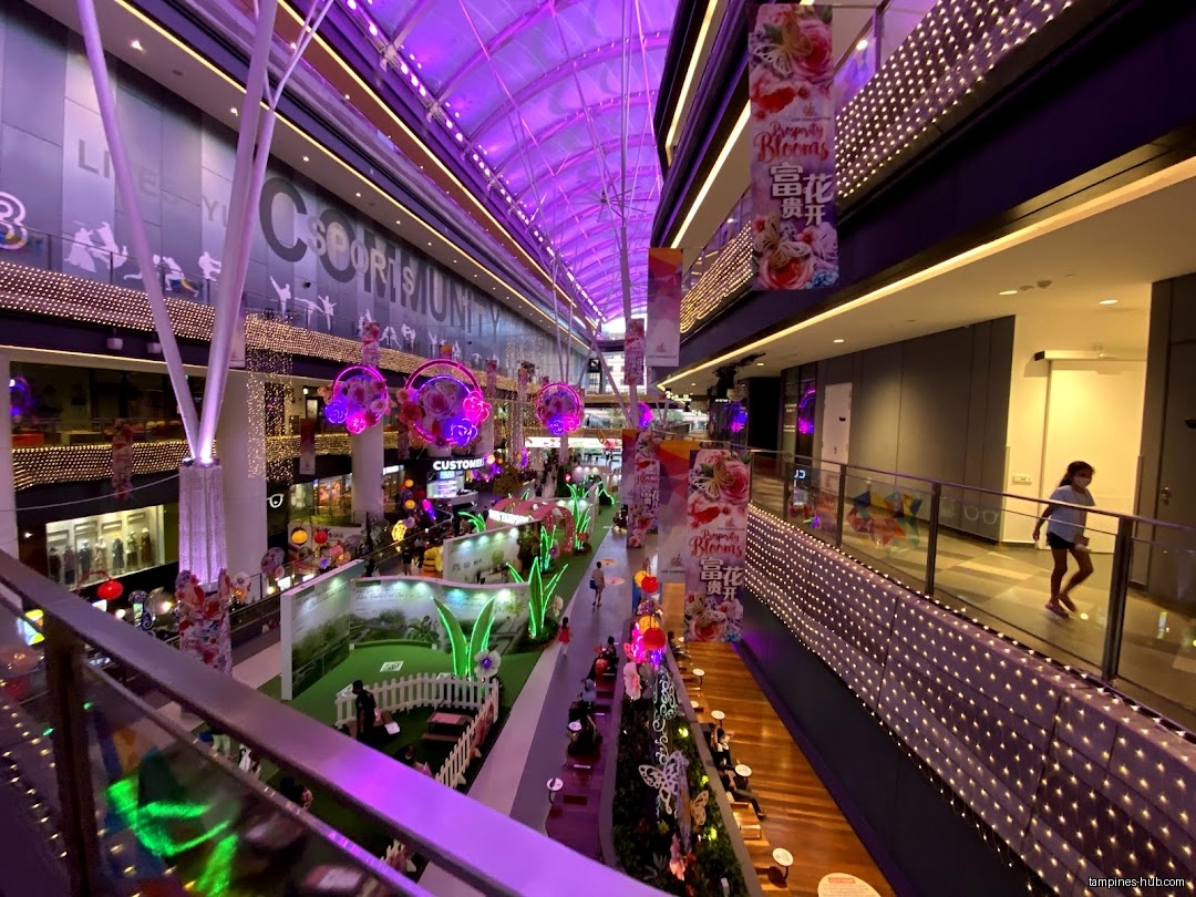 Interior view of Tampines ActiveSG Swimming Complex with decorations and people.