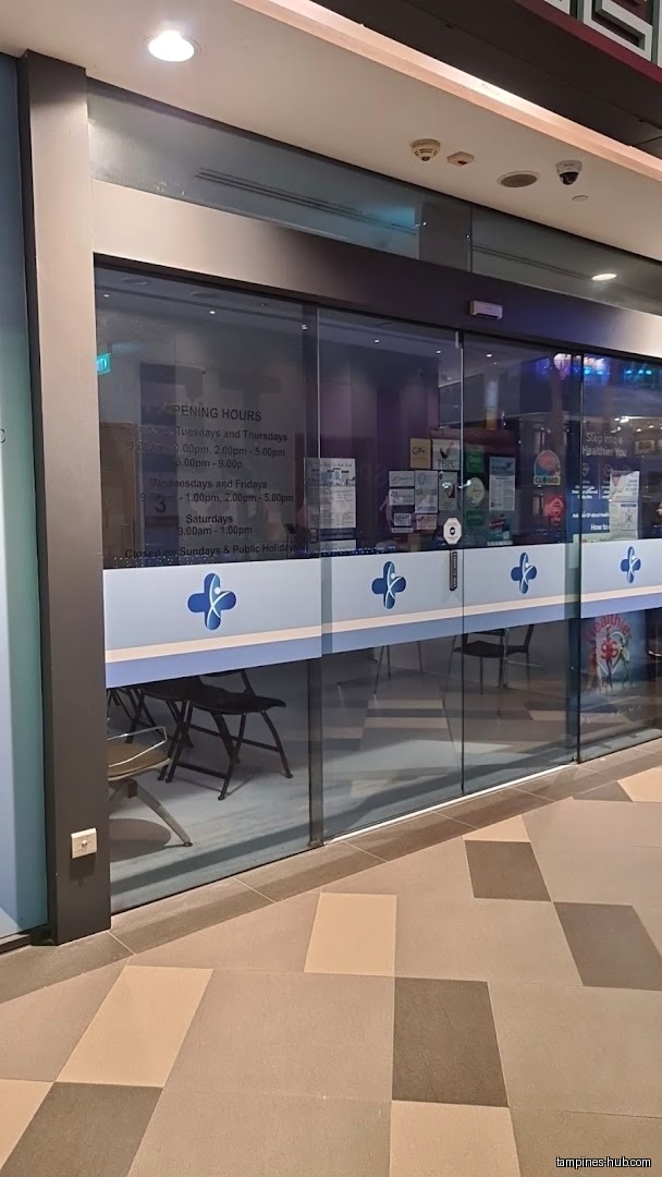 The Tampines Family Medicine Clinic's glass storefront displays opening hours.