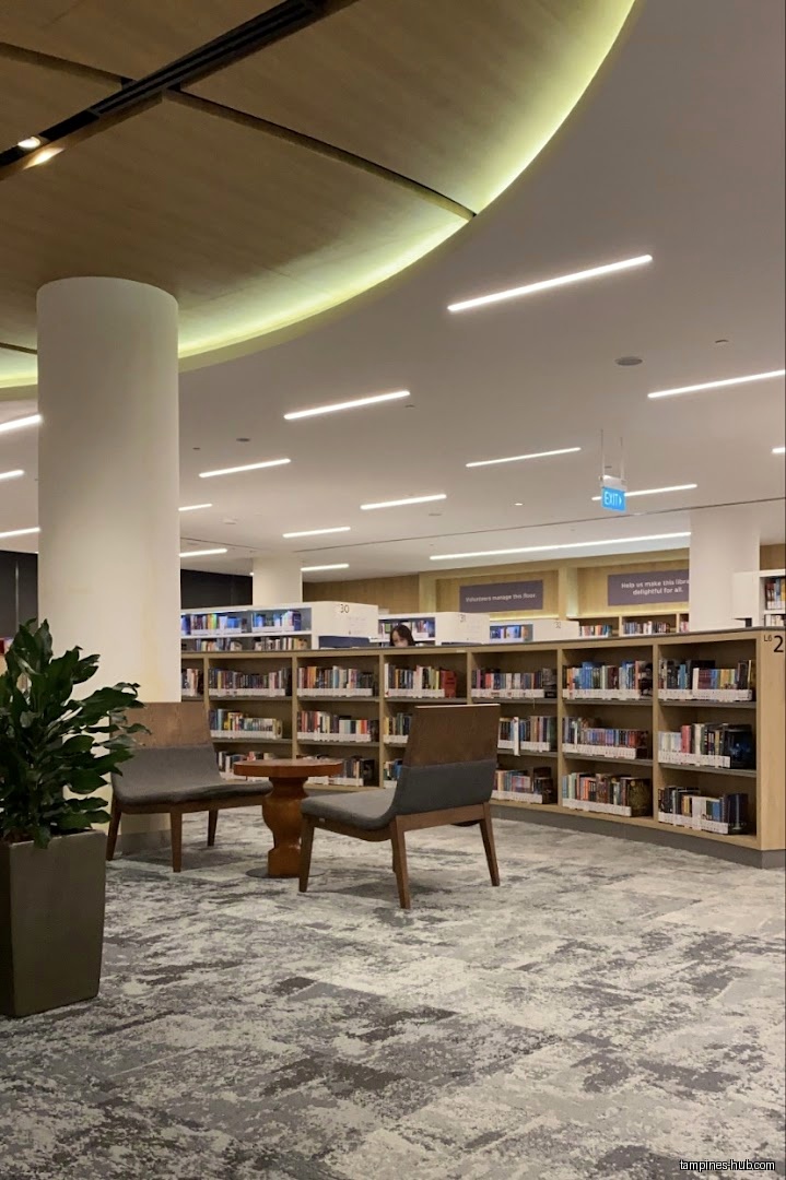 Interior shot of Tampines Regional Library with bookshelves and seating area.