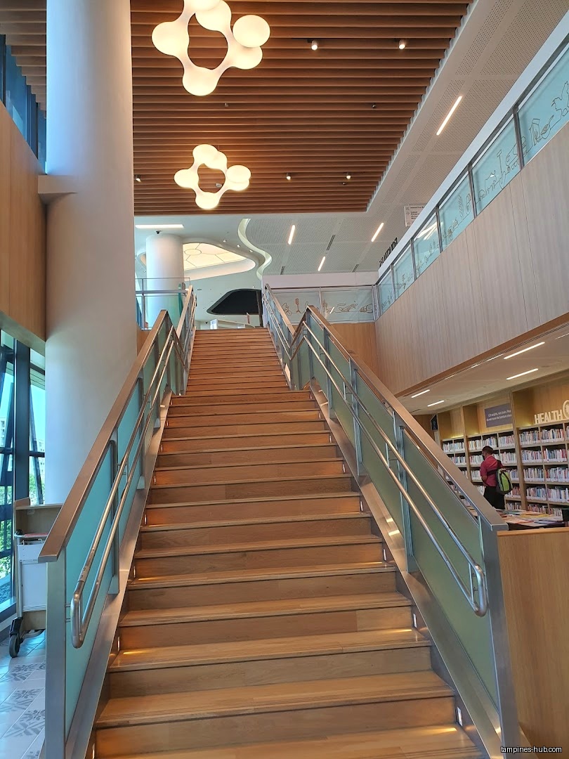 Interior view of Tampines Regional Library showing a staircase and bookshelves.