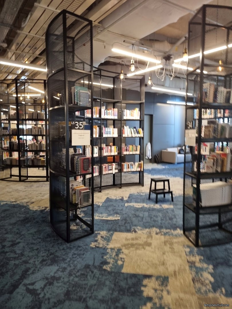 Interior view of Tampines Regional Library with bookshelves and seating.