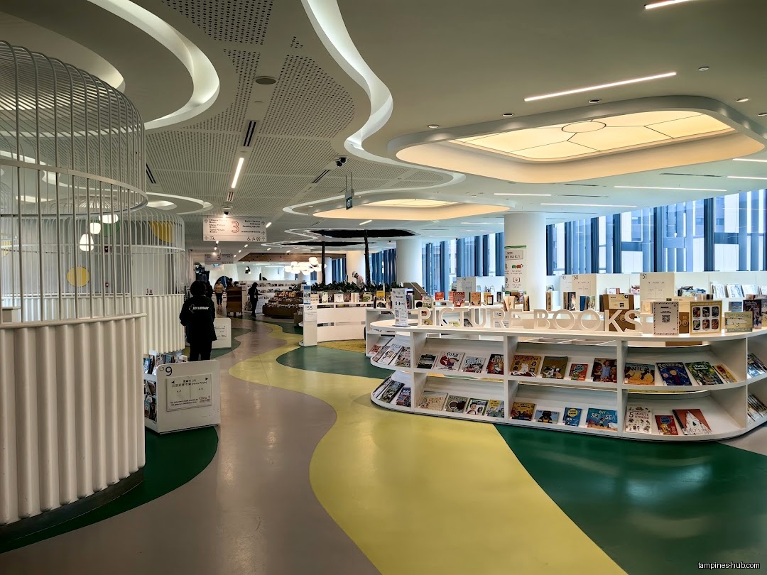 Interior view of Tampines Regional Library with bookshelves and colorful floor.