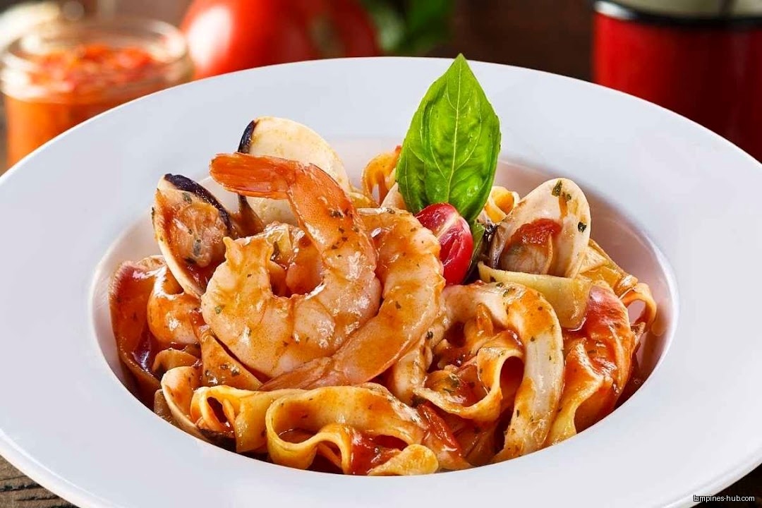 A plate of seafood pasta with shrimp, mussels, and tomato sauce.