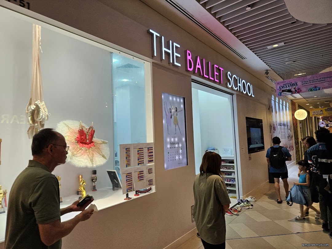 The Ballet School Singapore shop front with display and people passing by.