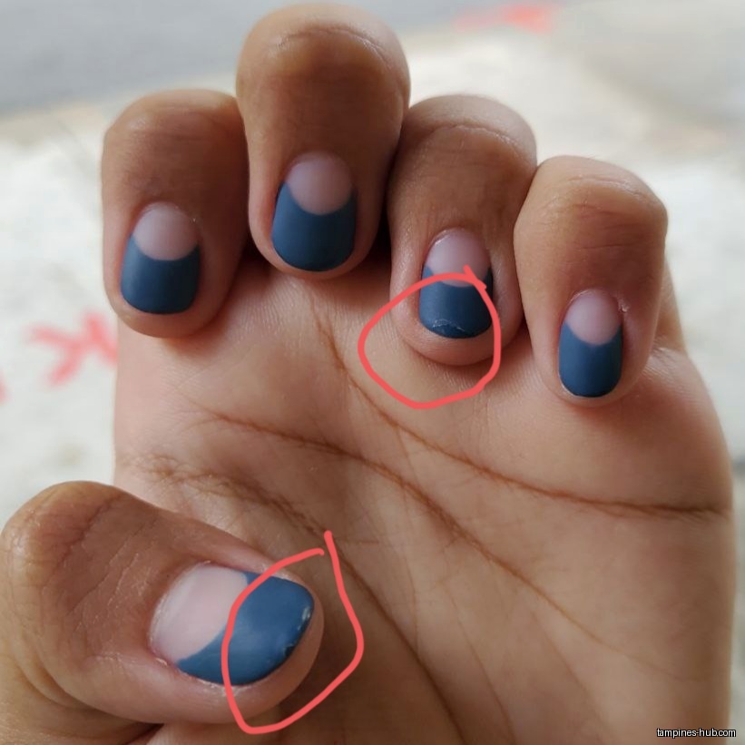 A hand with blue nail polish, some chipped, is shown.