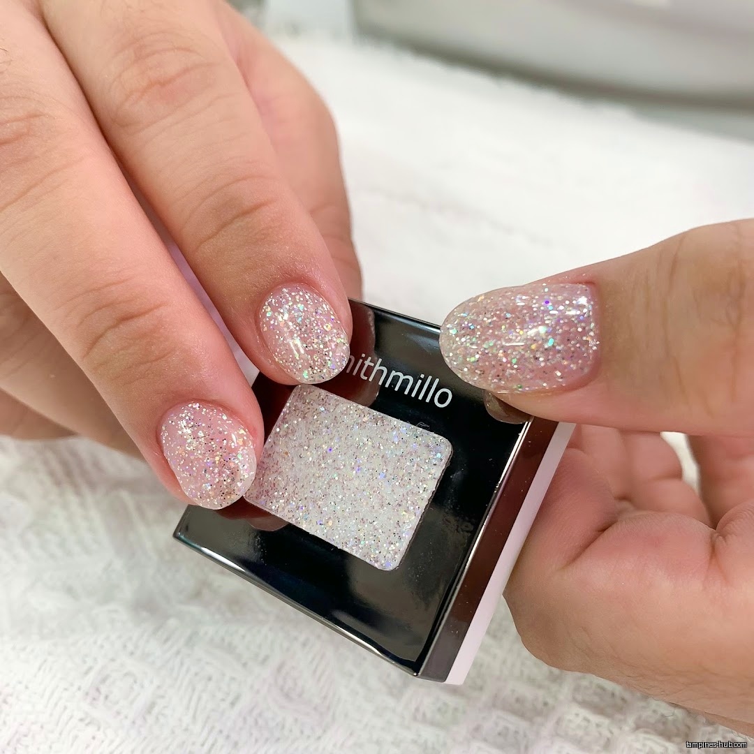 Hands with glittery nails hold a Smithmillo glitter product.