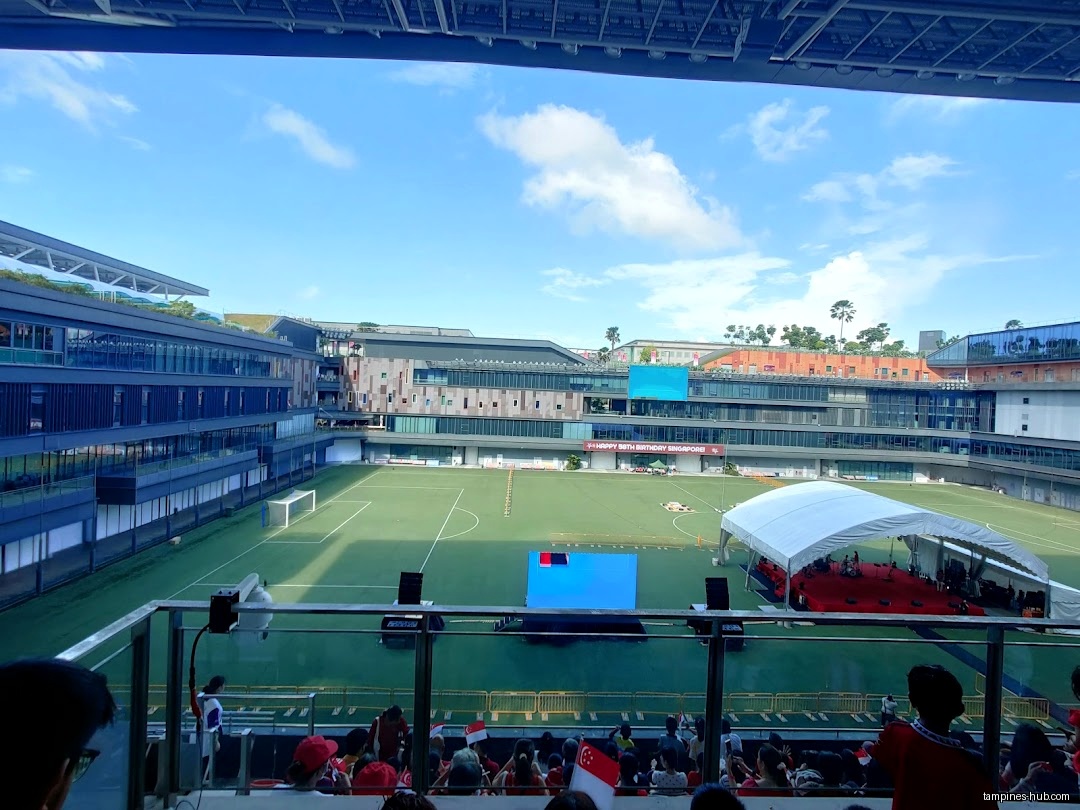 View of a stadium with a stage and audience from an elevated position.