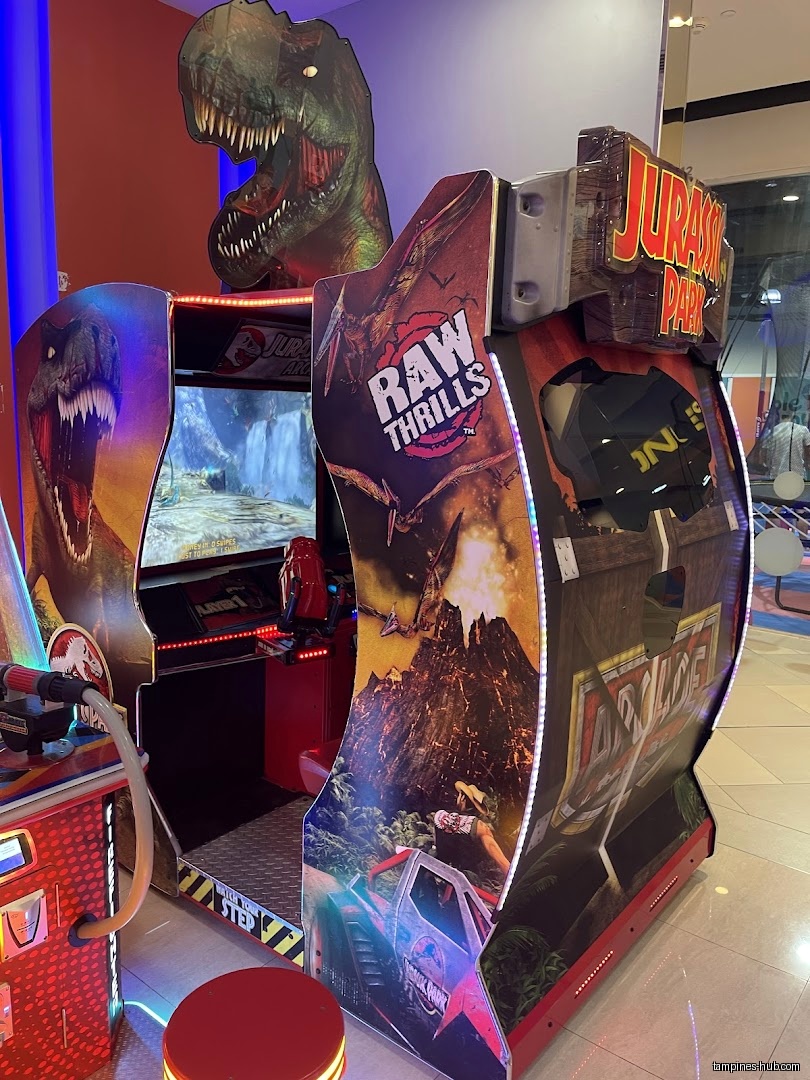 A Jurassic Park Raw Thrills arcade game is shown in the image.