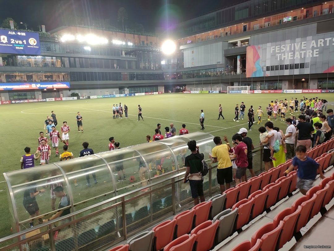 A soccer game is being played at Town Square, Our Tampines Hub.