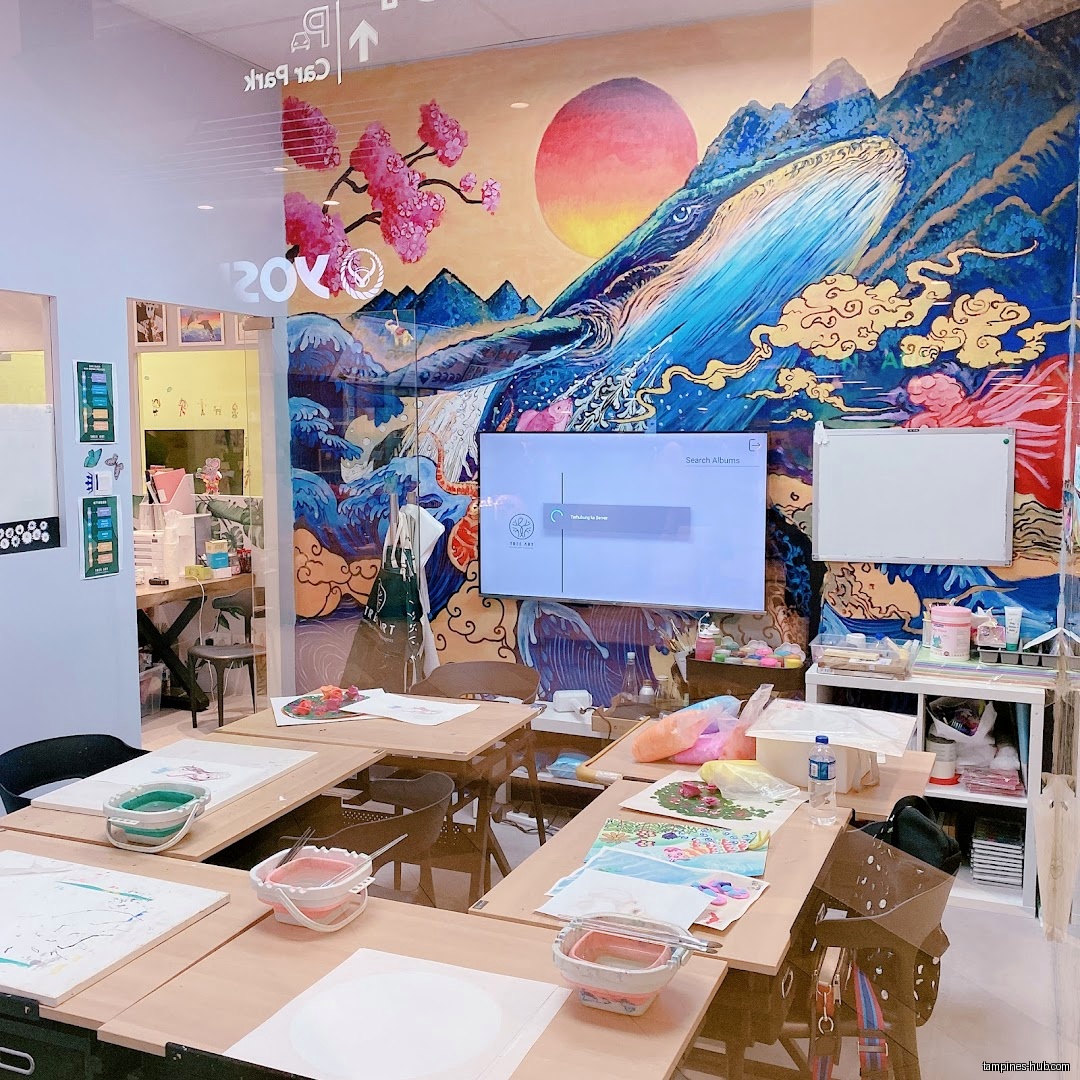 Interior of Tree Art (Tampines Campus) with tables, art supplies, and a mural.
