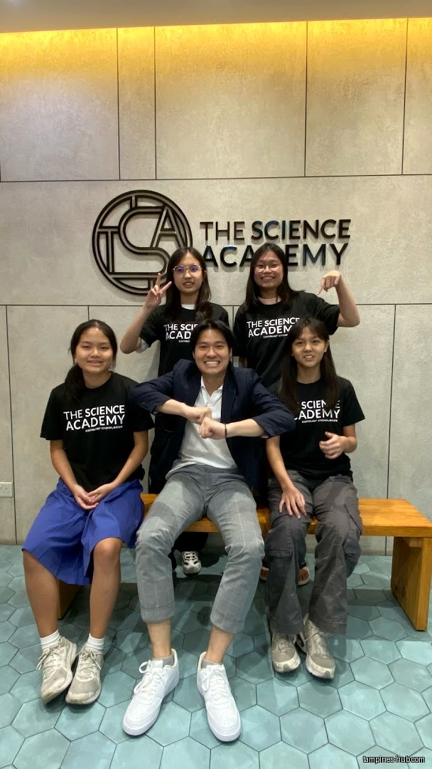 Group photo of staff and students in front of TSA The Science Academy.