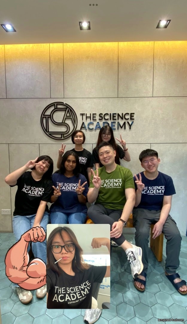 Group of people pose in front of The Science Academy logo.