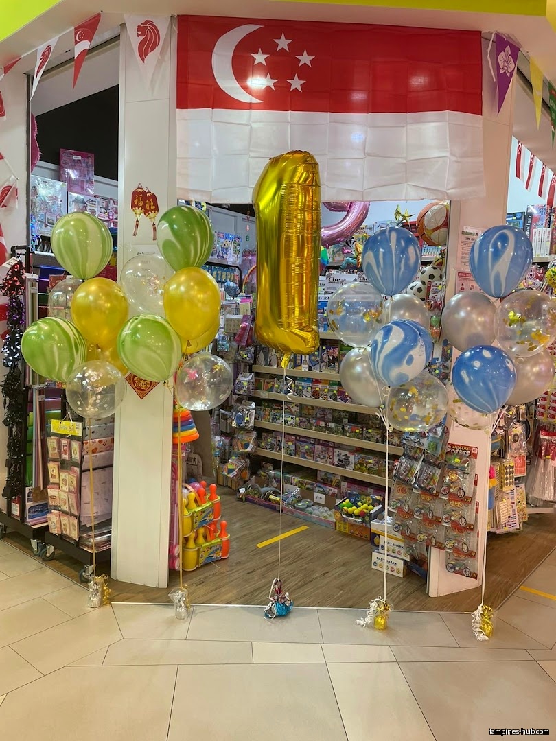 Shop front decorated with balloons and a Singapore flag.