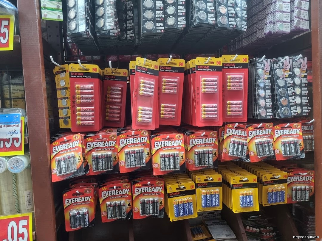 A shelf displays various brands and sizes of batteries for sale.
