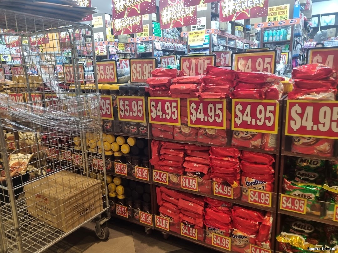 Aisles of products with large price tags in a Valu$ store.