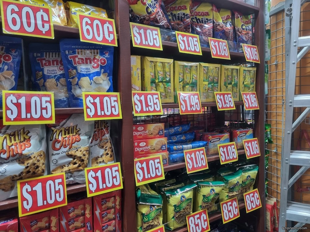 A shelf in Valu$ shop stocked with cookies and snacks with price tags.