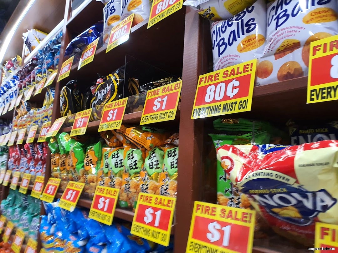 Shelves filled with various snacks and chips, marked with 'Fire Sale' signs.