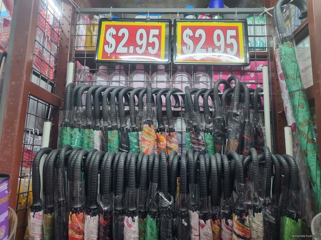 A display rack filled with umbrellas priced at $2.95 each.