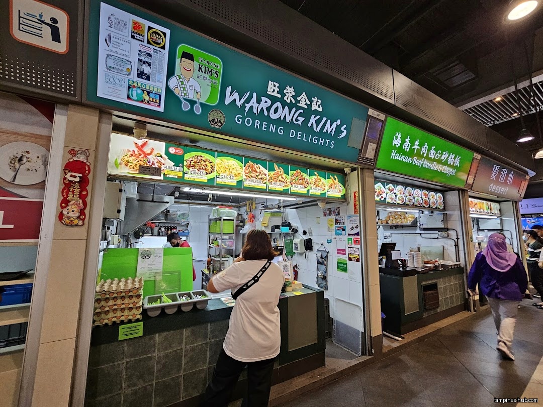 Warong Kim's Goreng Delights shop front with menu and customers.