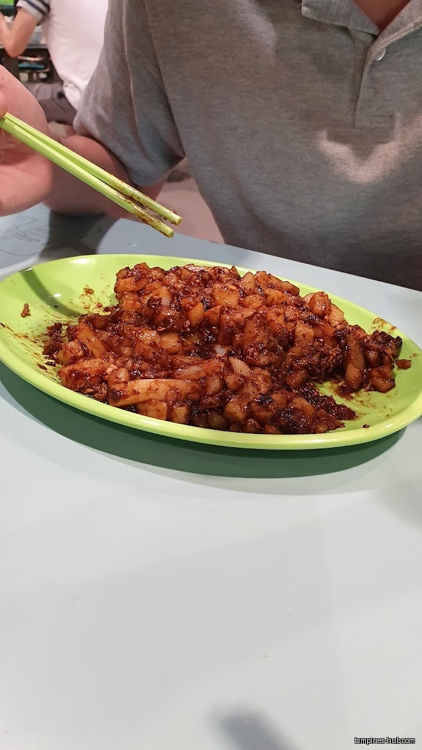 A plate of fried carrot cake with chopsticks at Warong Kim’s.