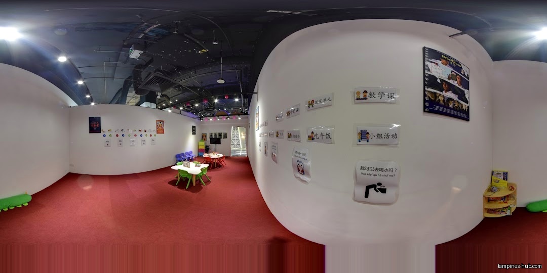 Interior of We Love SGP with tables, chairs, and educational posters.