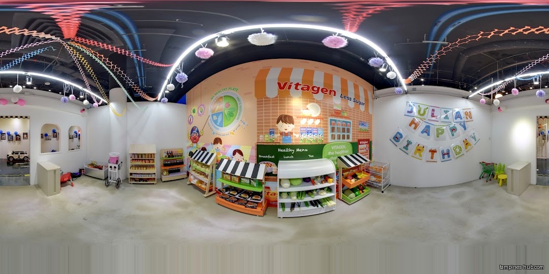 The image shows an indoor play area with food-themed displays and decorations.