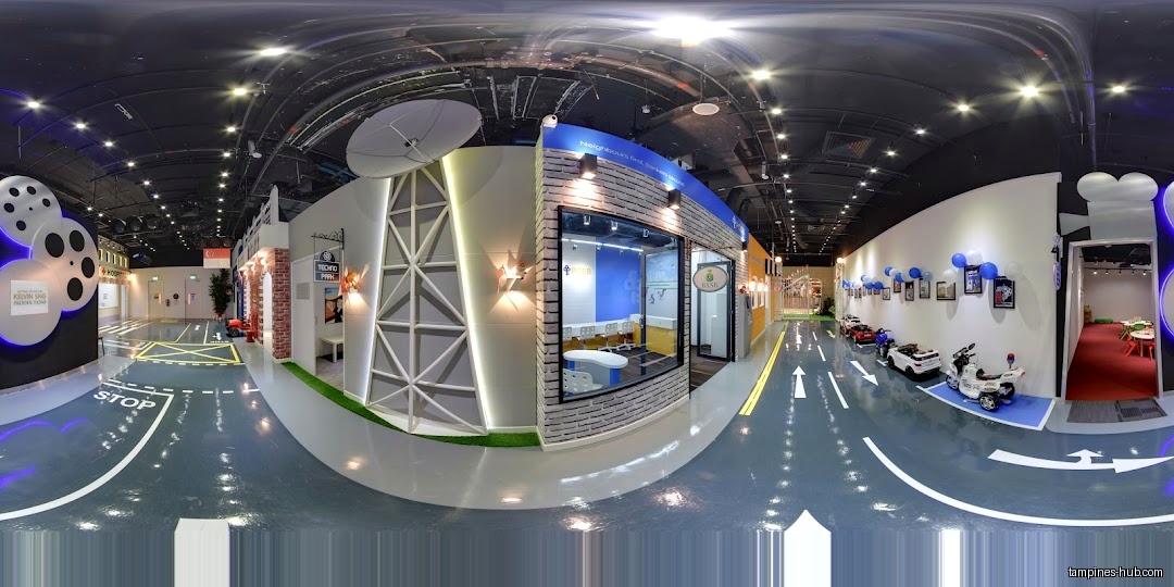 The image shows an indoor play area designed like a miniature city street.