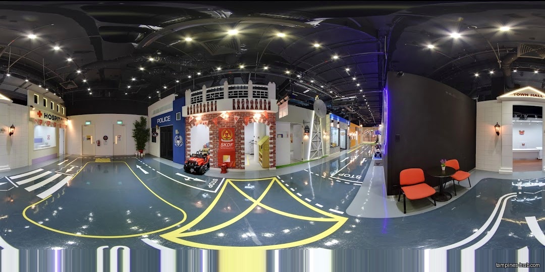 The image shows an indoor play area designed like a miniature city.