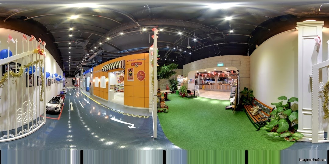 The image shows an indoor play area designed like a small town.