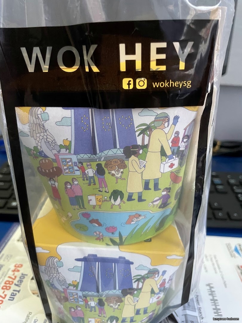 A Wok Hey branded container with a cartoon Singapore scene is shown.