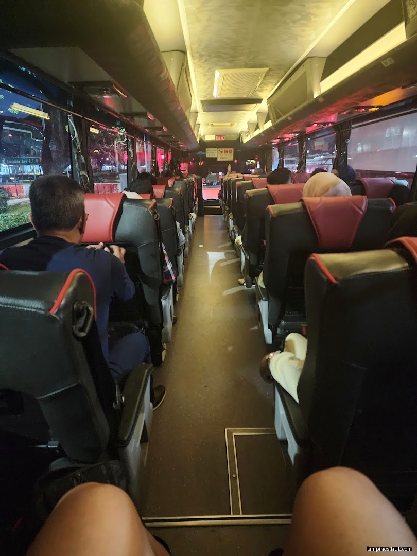 Interior view of a bus with passengers in seats.