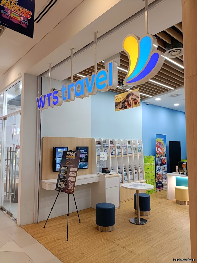 The WTS Travel & Tours shop front with brochures and digital displays.