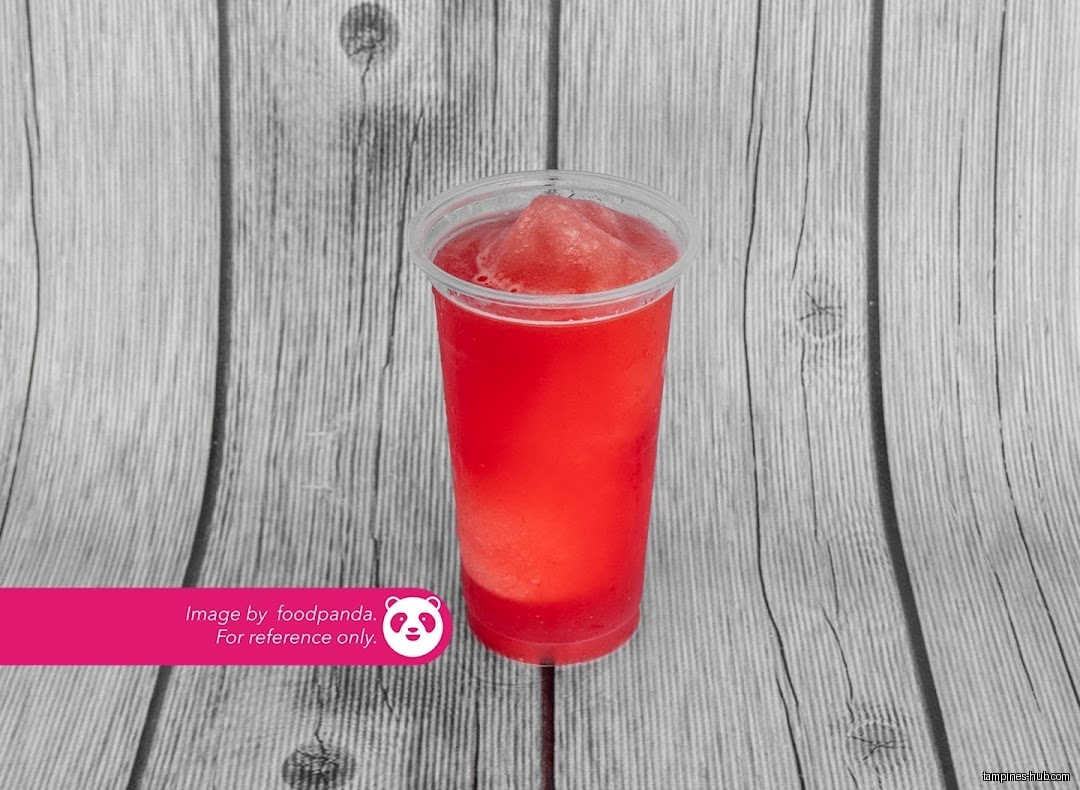 A red slush drink in a clear plastic cup on a wooden surface.
