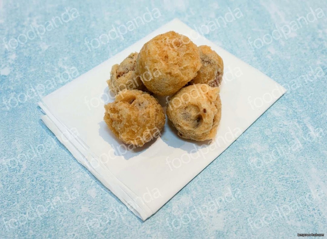 A pile of fried dough balls on a white napkin.