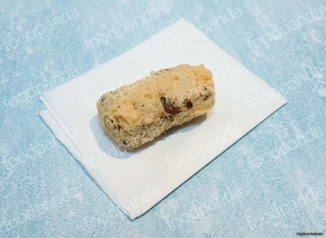 A fried food item sits on a white napkin against a blue background.